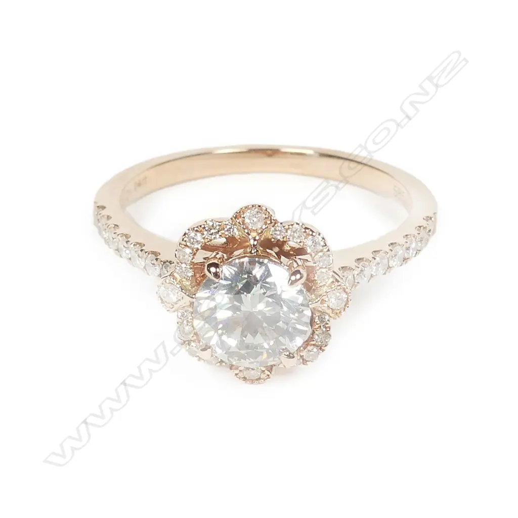 A 14ct rose gold and diamond halo ring Image 1++