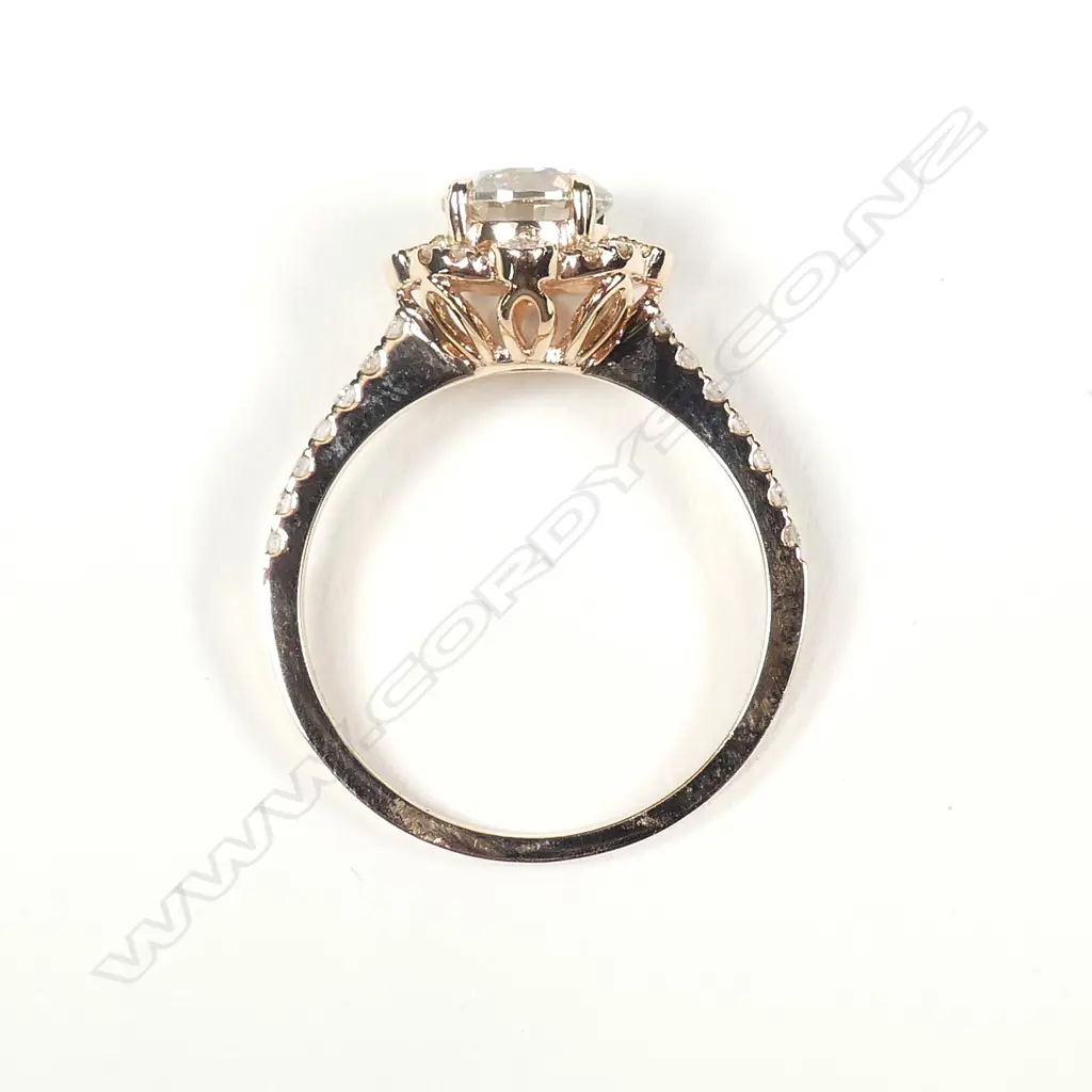 A 14ct rose gold and diamond halo ring Image 1++