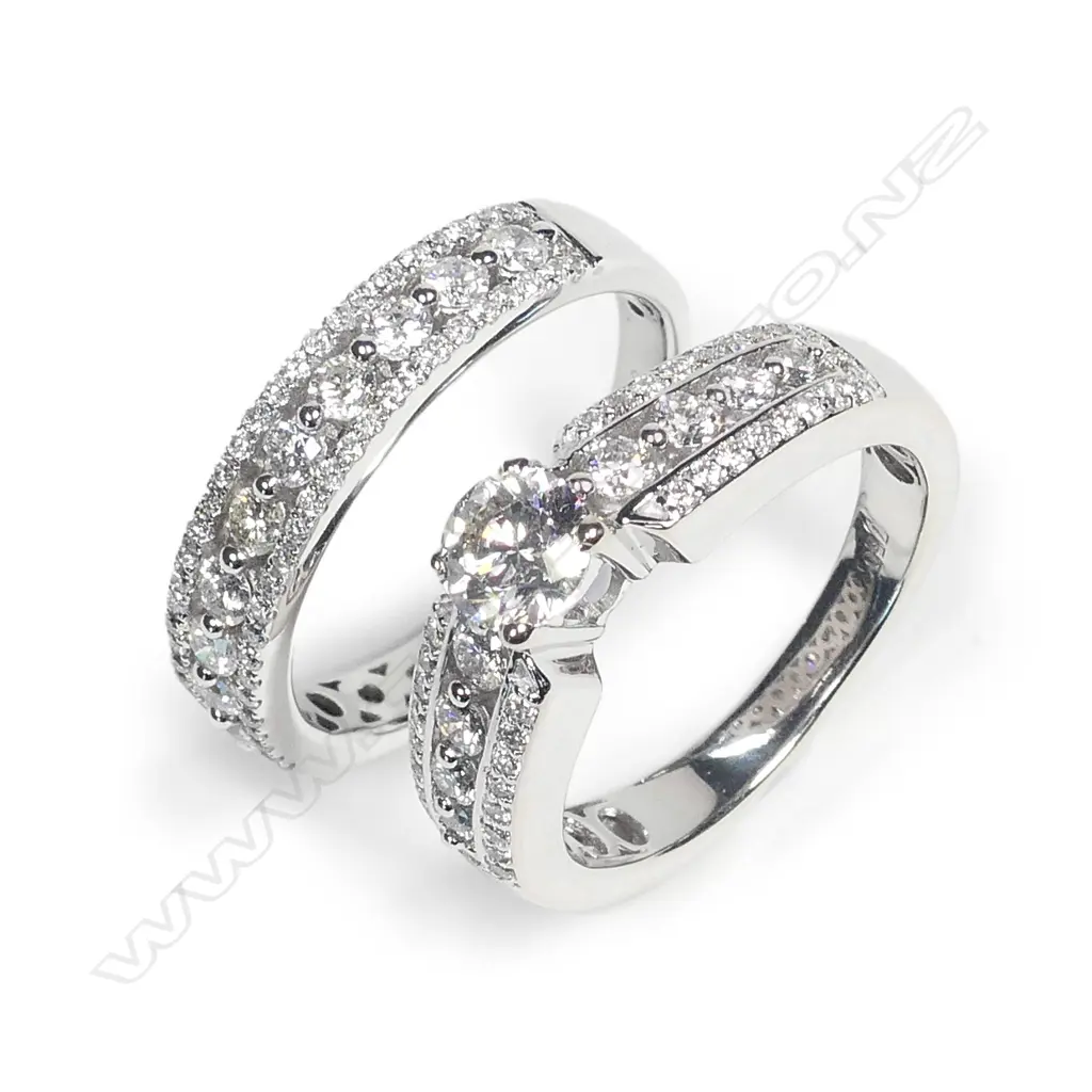 A pair of modern 18ct. white gold and diamond engagement and wedding rings Image 1++