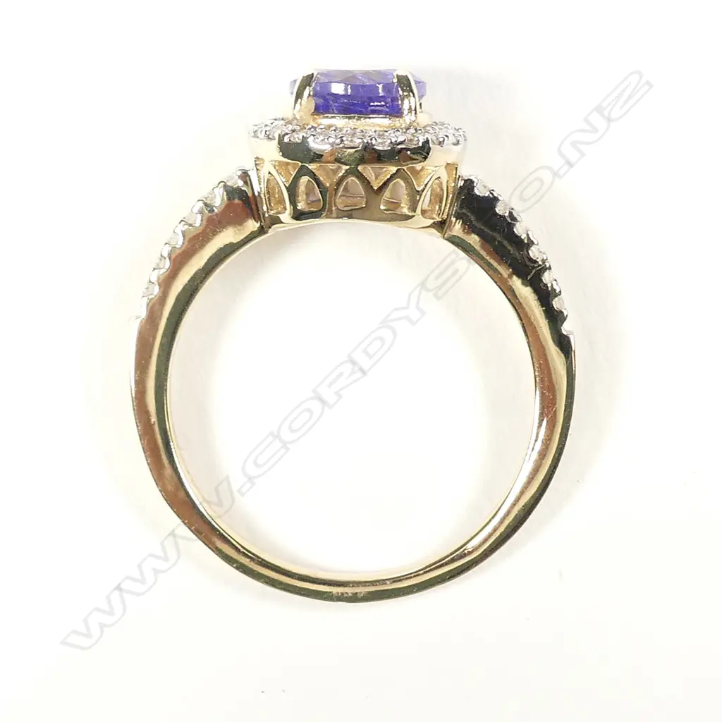 A 14ct gold tanzanite and diamond halo ring Image 1++