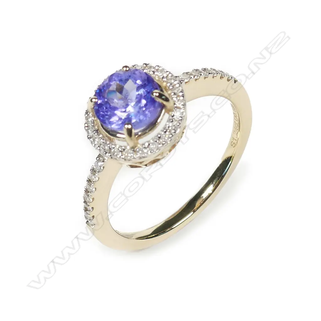 A 14ct gold tanzanite and diamond halo ring Image 1++
