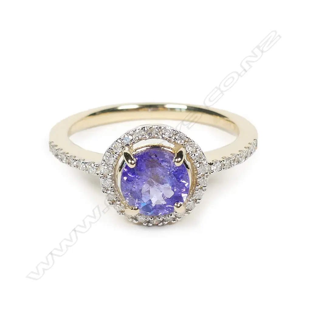 A 14ct gold tanzanite and diamond halo ring Image 1++
