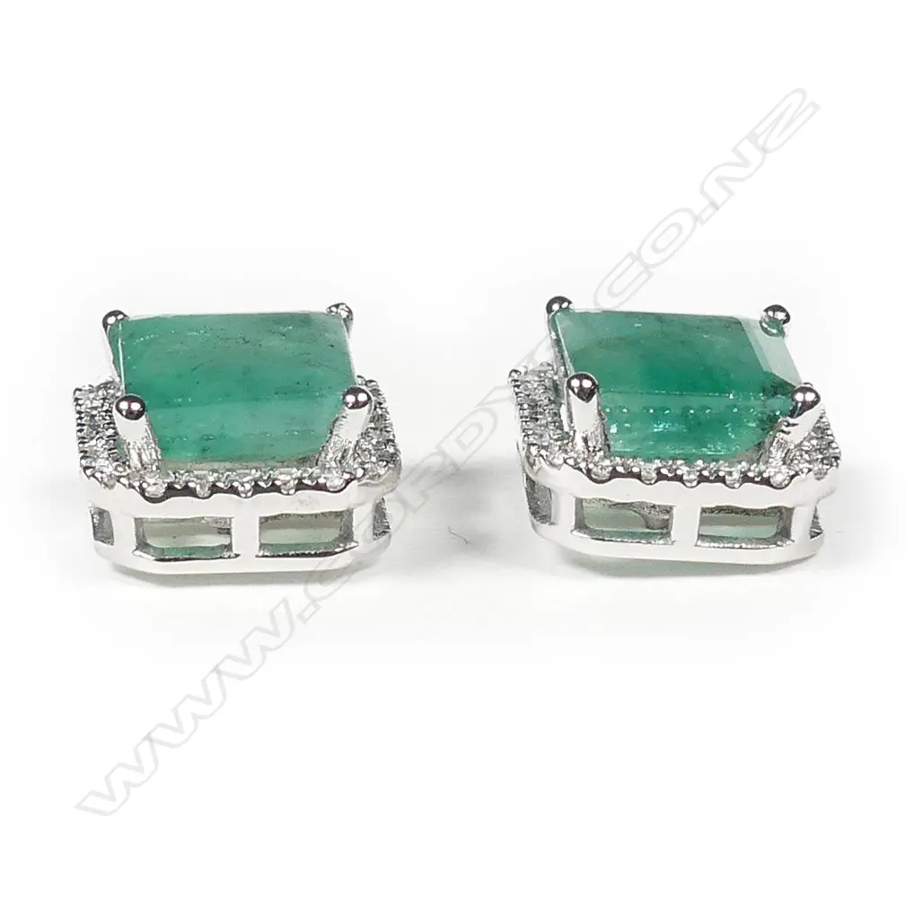 A pair of 14ct white gold emerald and diamond halo stud earrings Image 1++