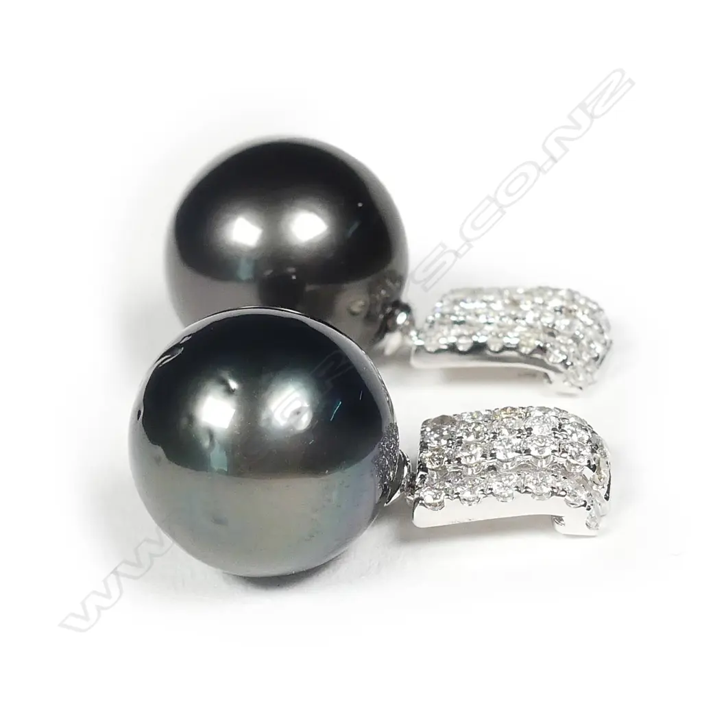 A pair of 14ct white gold pearl and diamond earrings Image 1++