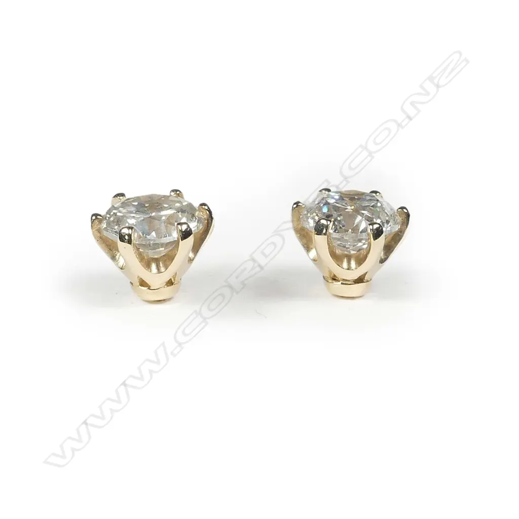 A pair of 14ct gold and diamond stud earrings Image 1++
