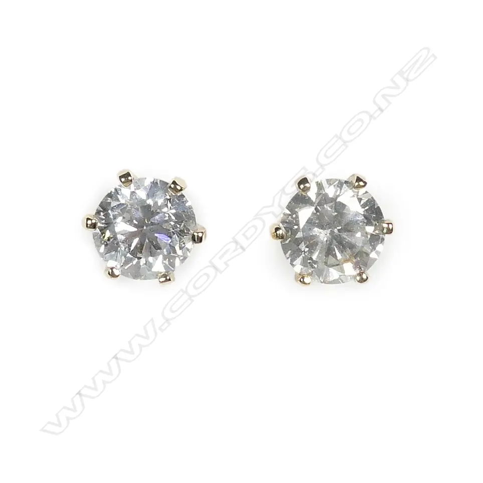A pair of 14ct gold and diamond stud earrings Image 1++