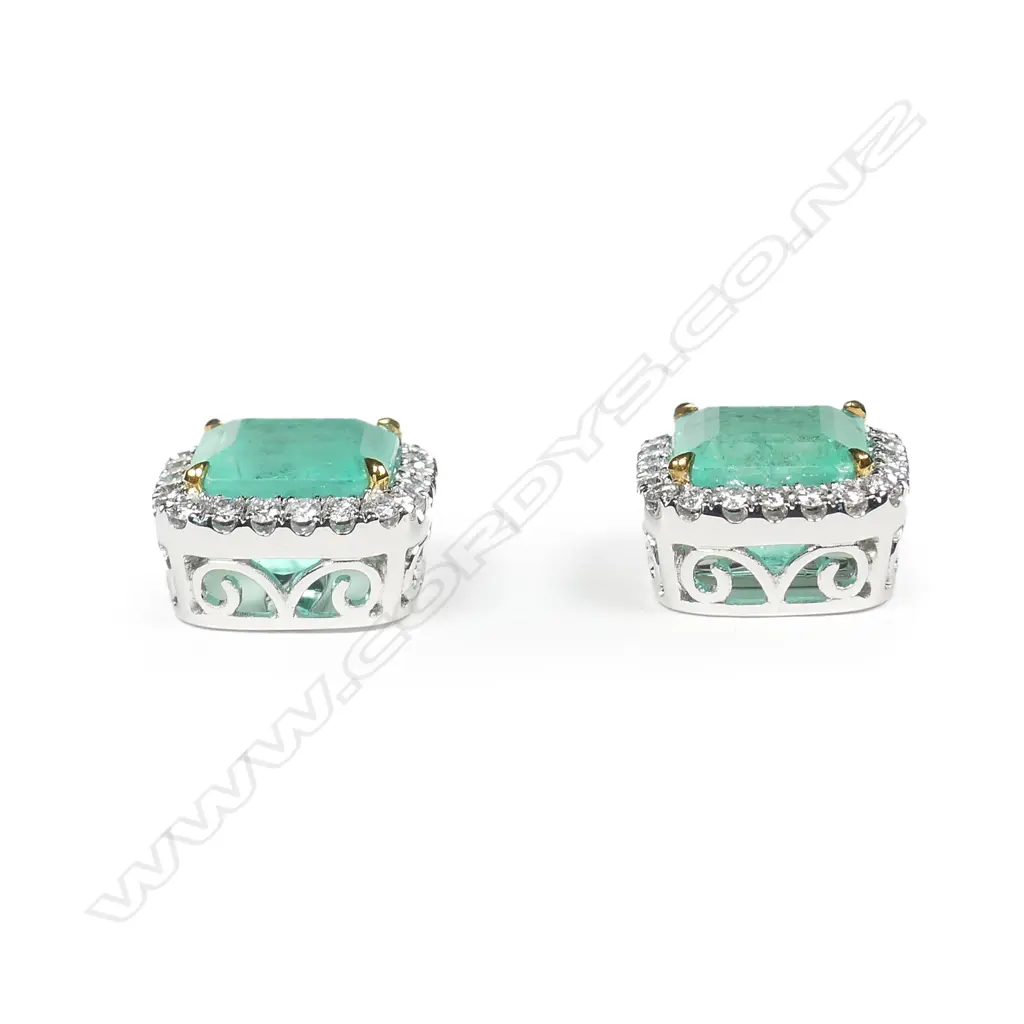 A stylish pair of platinum emerald and diamond stud earrings Image 1++