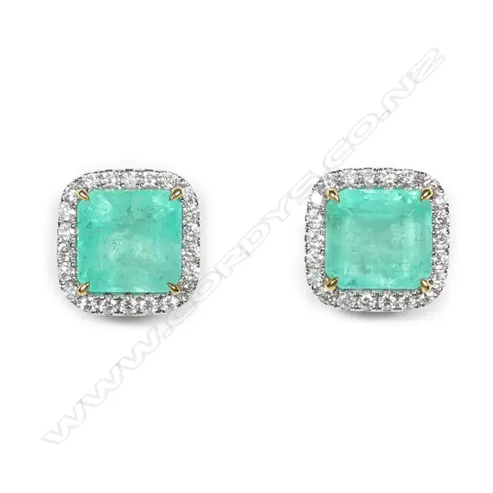 A stylish pair of platinum emerald and diamond stud earrings