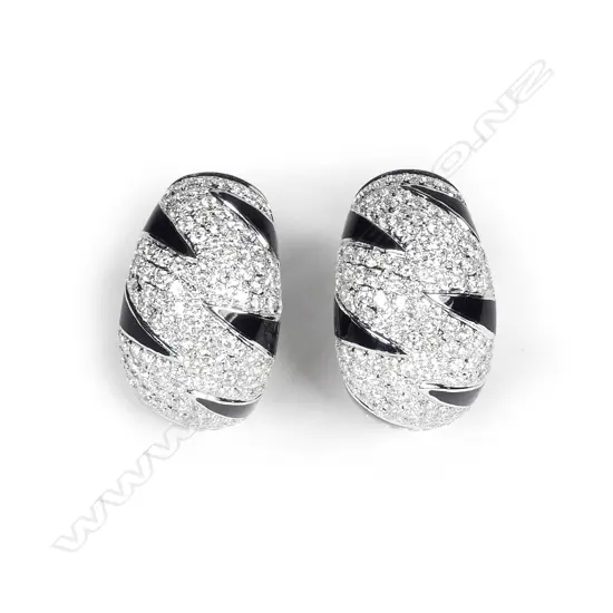 A pair of modern 18ct. white gold diamond and black enamel striking earrings