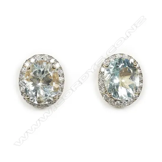 A pair of 14ct gold aquamarine and diamond halo earrings