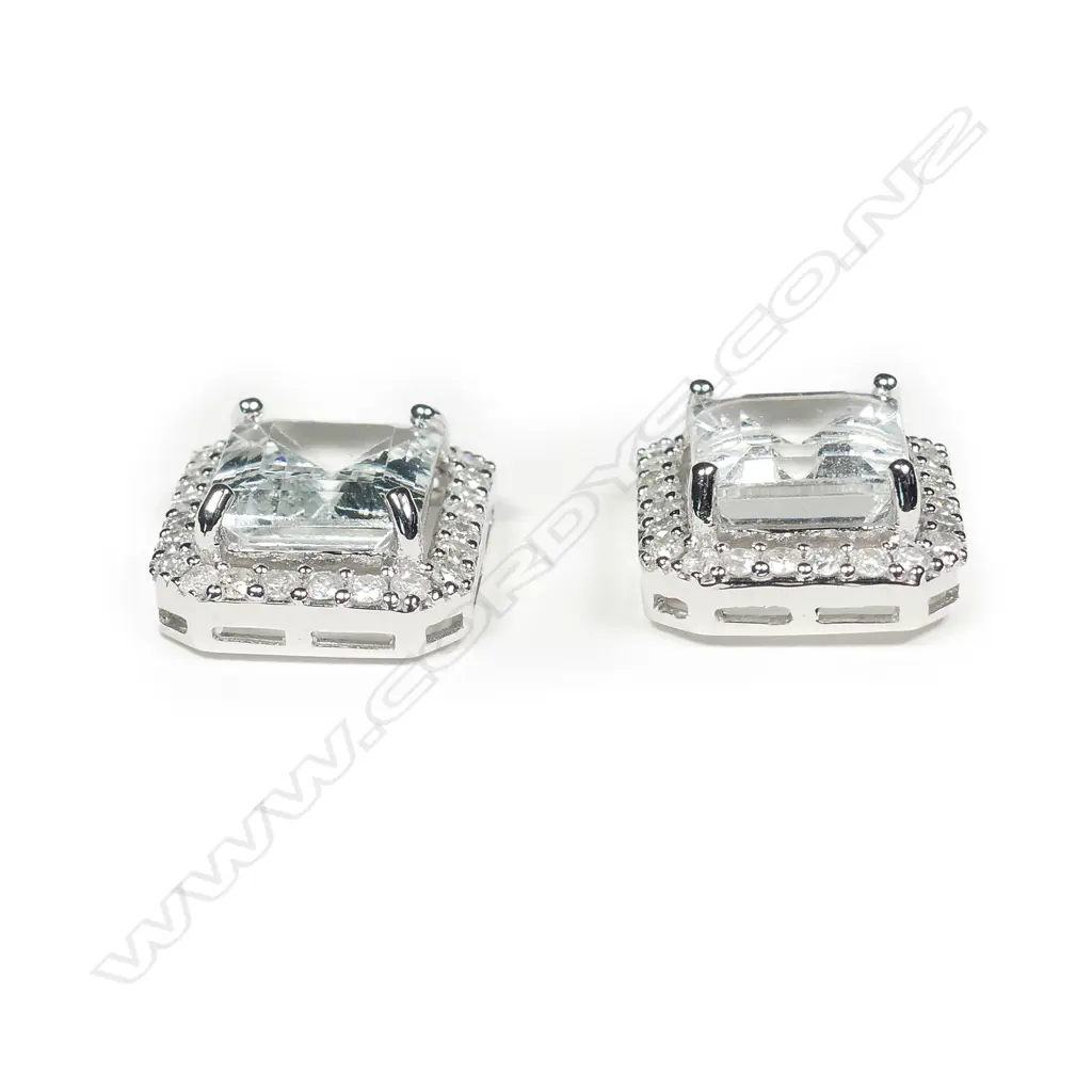 A pair of 14ct white gold aquamarine and diamond stud earrings Image 1++