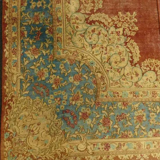 A large antique Persian Kerman hand knotted carpet