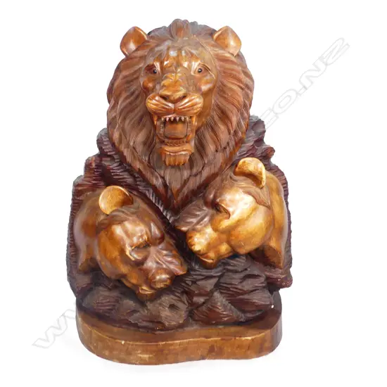A large hardwood carving of a lion group