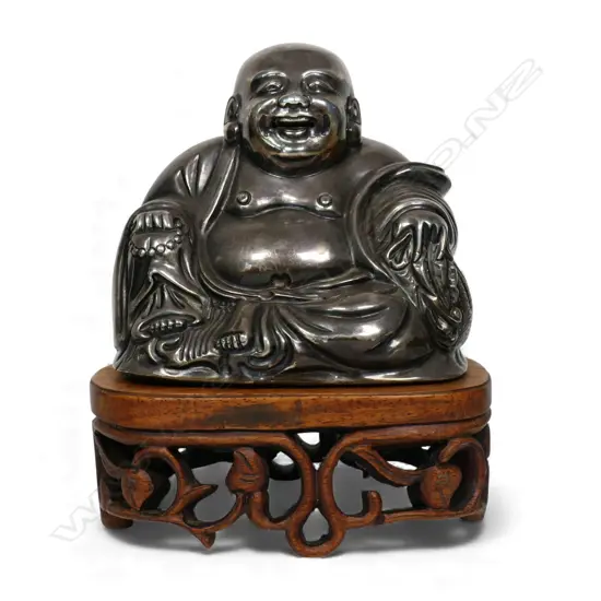 A vintage Oriental silver seated buddha,