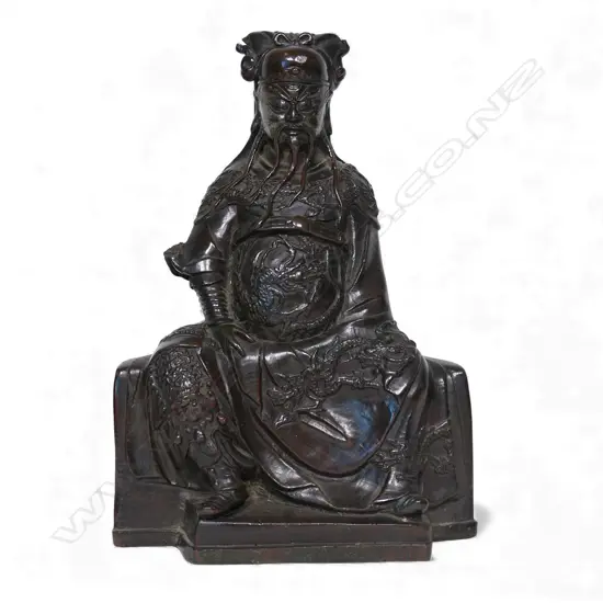 A Chinese reputedly Ming bronze model of a seated and bearded official,