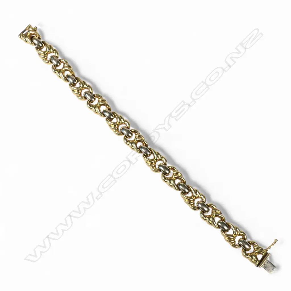 An 18ct two tone yellow and white gold designer link bracelet, Image 1++