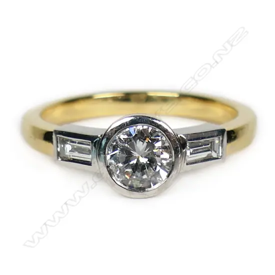 An 18ct white and yellow gold diamond solitaire ring,