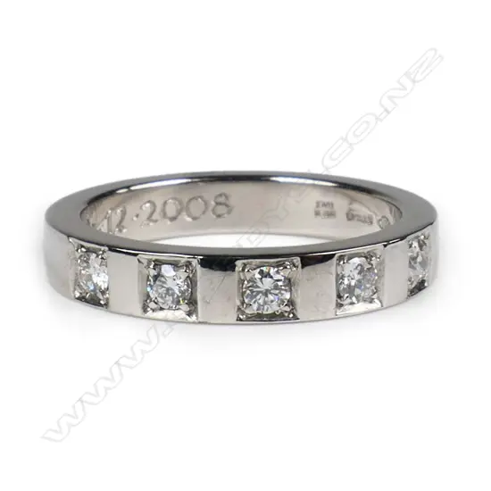A platinum and diamond band ring,