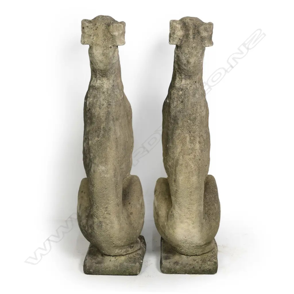 A pair of classical Church Stone greyhounds, in seated position, on small plinth base, weathered patina. H.750mm. Image 1++