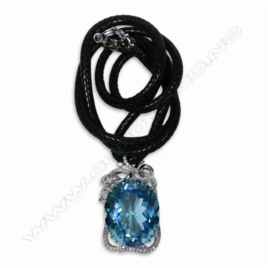 An 18ct white gold diamond and large blue topaz pendant,