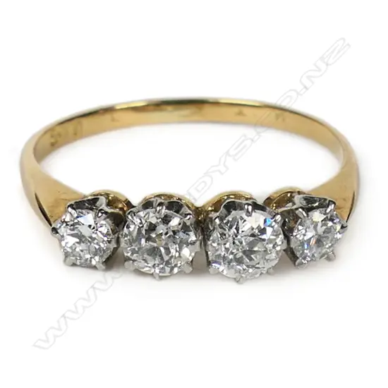 An 18ct gold and four stone diamond ring,