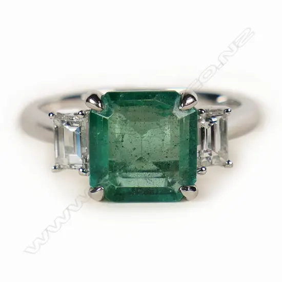 A good 18ct white gold emerald and diamond ring,