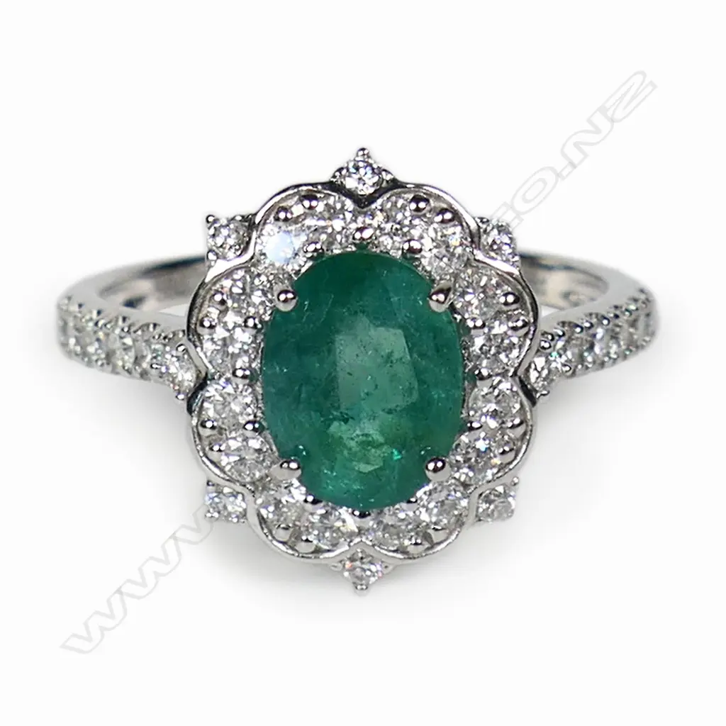 A 14ct white gold emerald and diamond dress ring, Image 1++