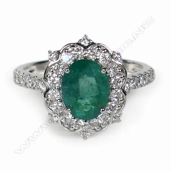 A 14ct white gold emerald and diamond dress ring,