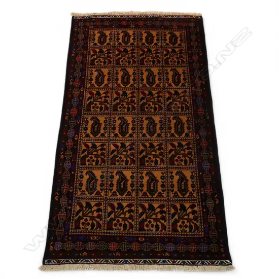 A hand-knotted Baluch rug,