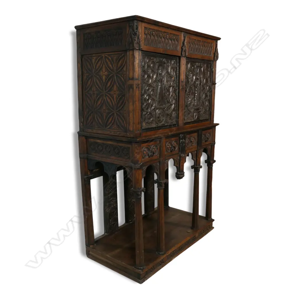An uncommon and very decorative 19thC oak carved ecclesiastical carved cupboard on raised stand, Image 1++