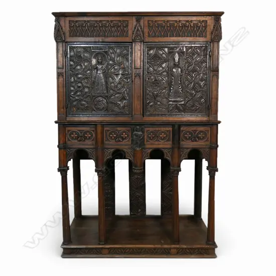 An uncommon and very decorative 19thC oak carved ecclesiastical carved cupboard on raised stand,