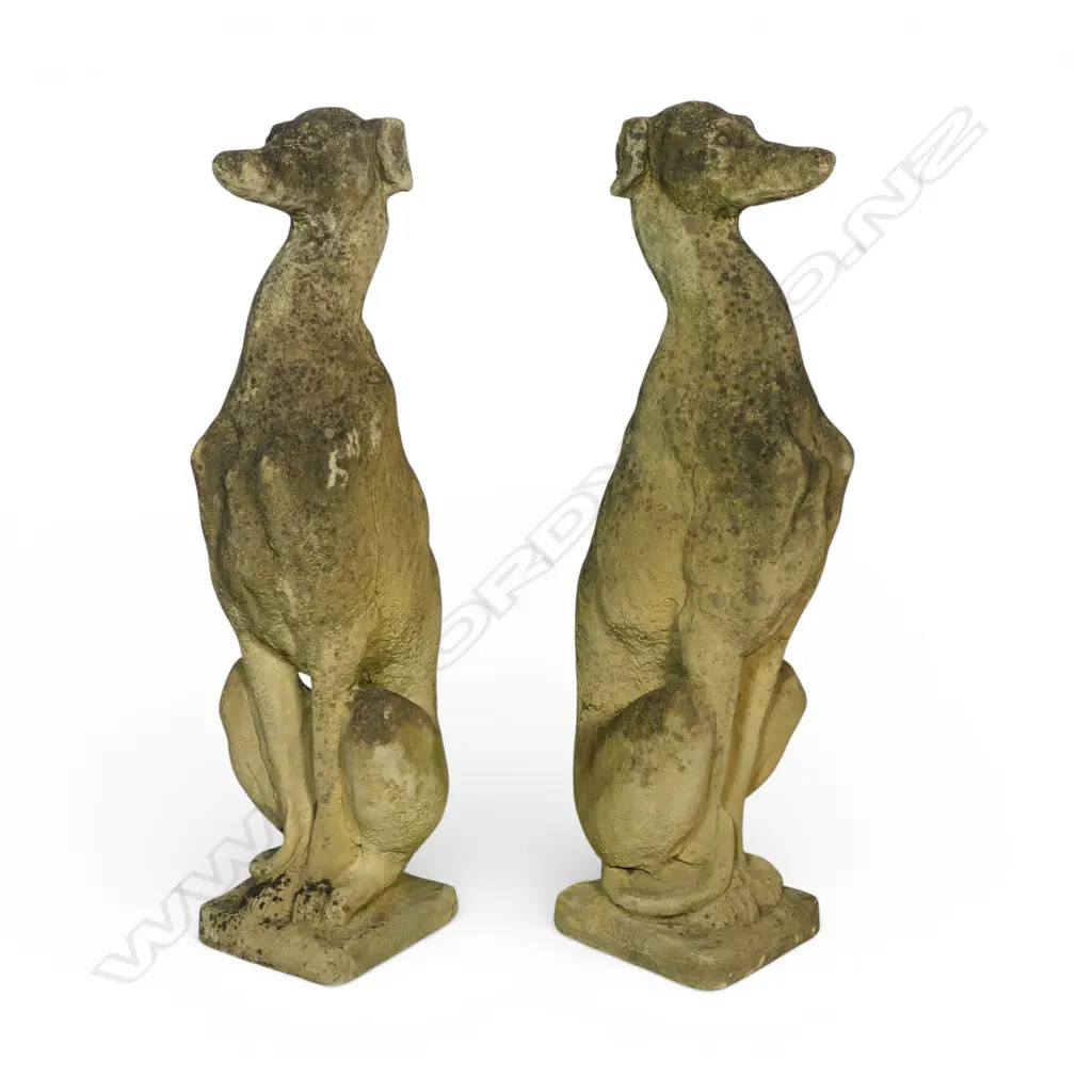 A pair of classical Church Stone greyhounds, in seated position, on small plinth base, weathered patina. H.750mm. Image 1++