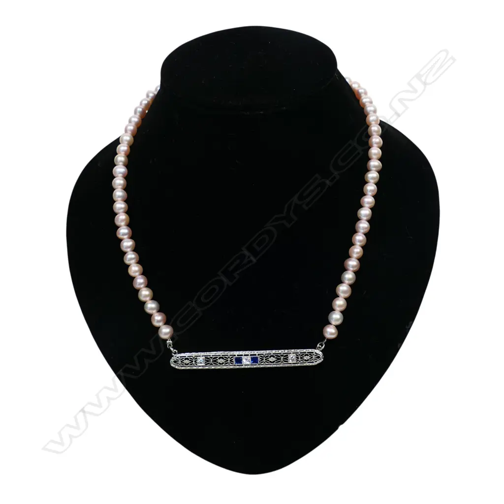 A cultured freshwater peach pearl necklace with platinum, sapphire and diamond set bar, Image 1++