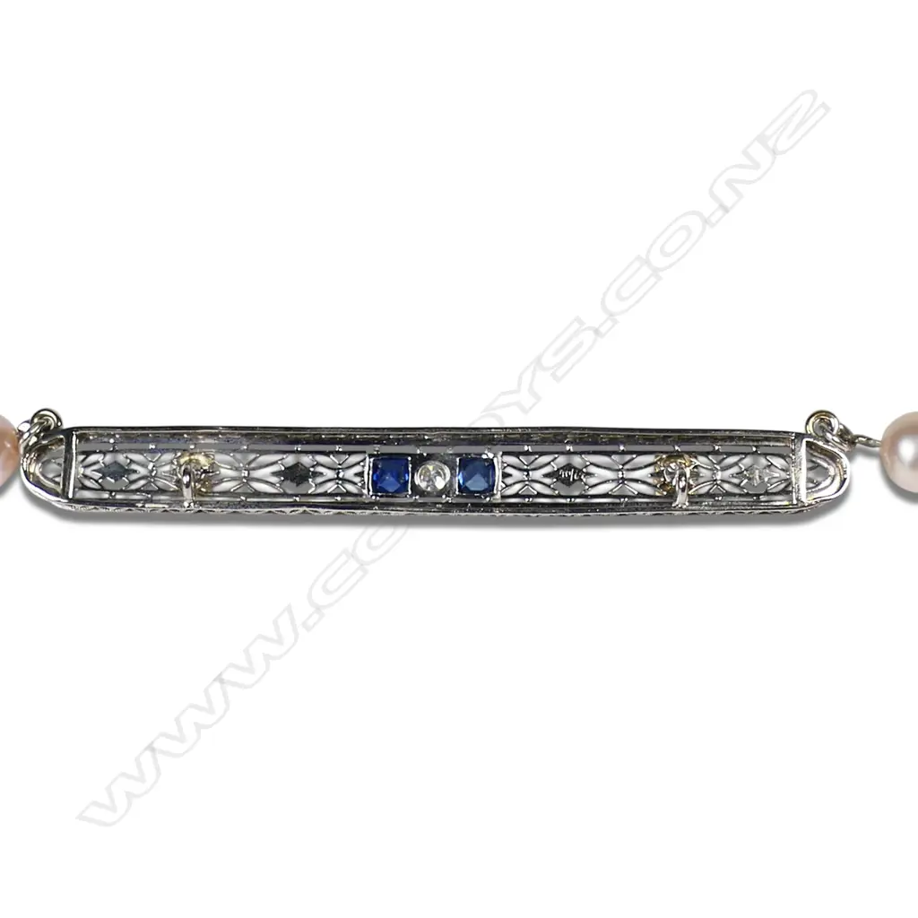 A cultured freshwater peach pearl necklace with platinum, sapphire and diamond set bar, Image 1++