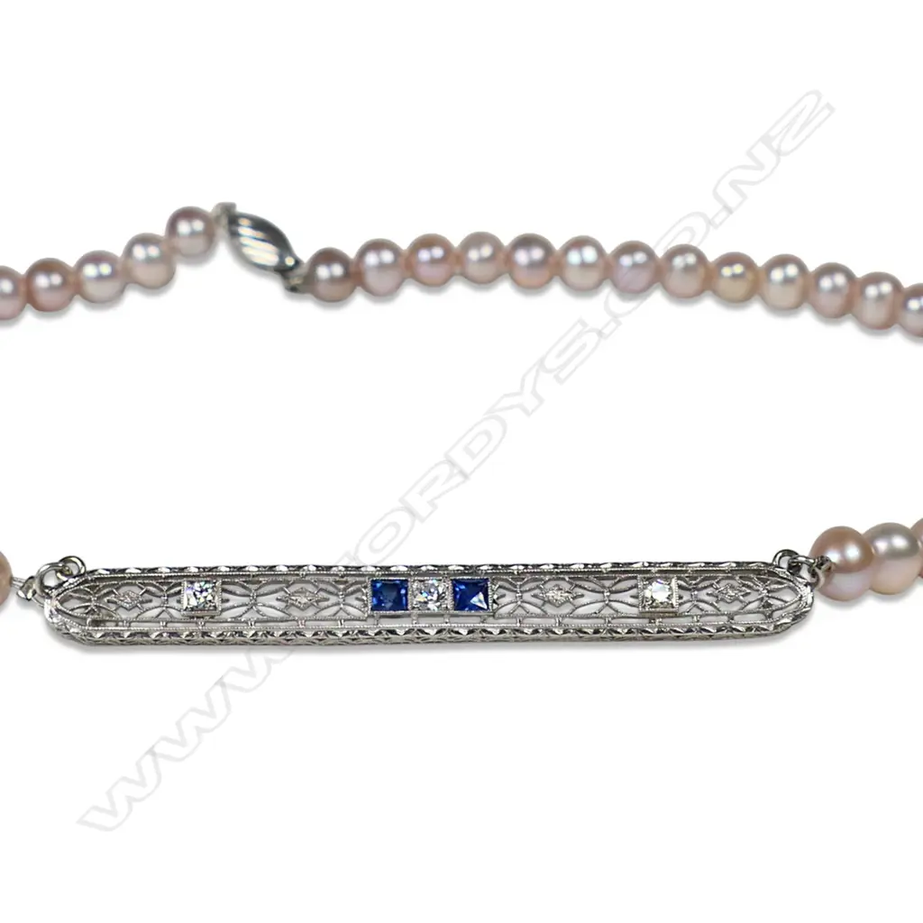 A cultured freshwater peach pearl necklace with platinum, sapphire and diamond set bar, Image 1++