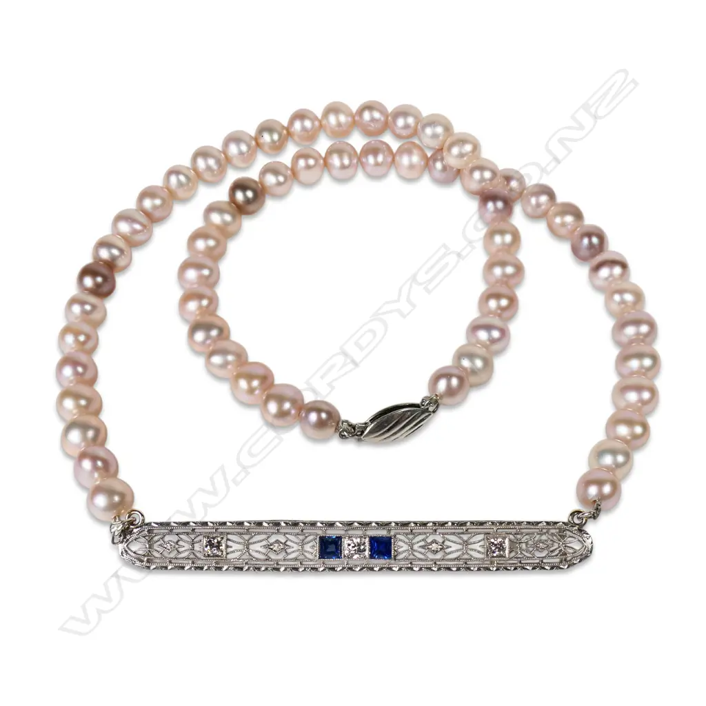 A cultured freshwater peach pearl necklace with platinum, sapphire and diamond set bar, Image 1++
