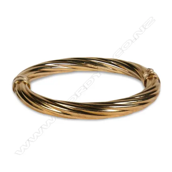 A 9ct gold hinged bangle,
