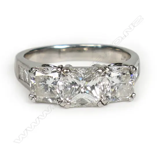 A platinum and three stone diamond dress ring,