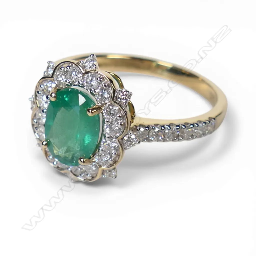 A 14ct gold emerald and diamond halo ring, Image 1++
