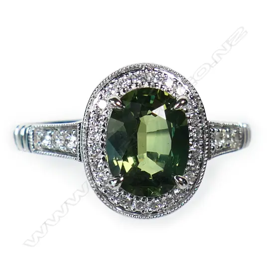 An 18ct white gold green sapphire and diamond ring,