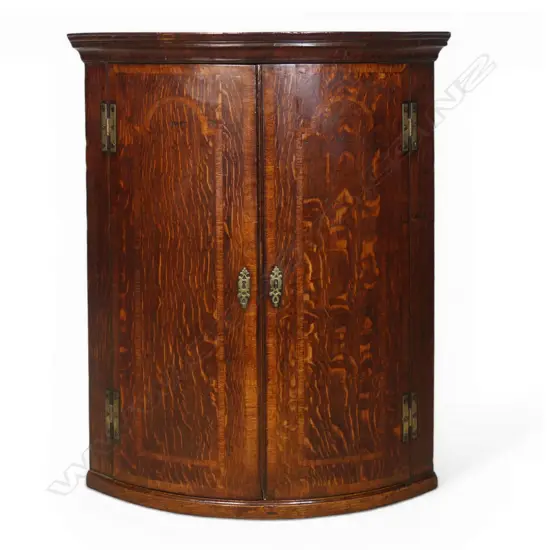 A Georgian oak corner cupboard,