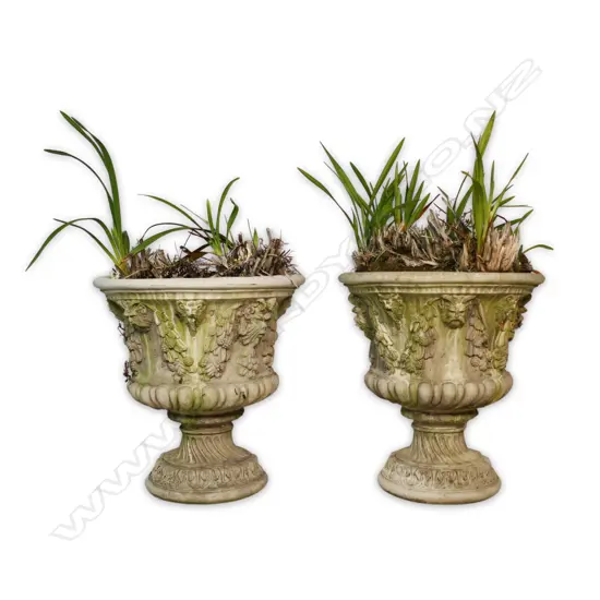 A pair of concrete antique style garden urns,