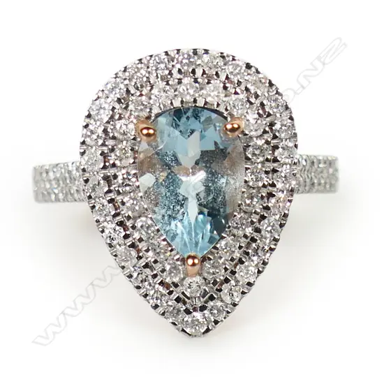 A 14ct rose gold aquamarine and diamond double halo ring,
