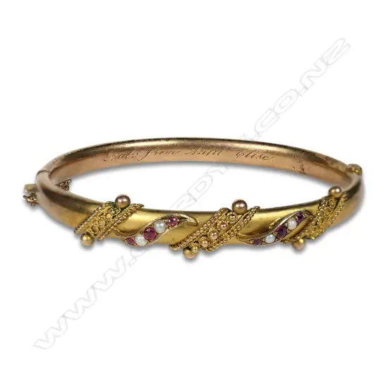 Edwardian 9ct gold ruby and seed pearl hinged bangle,