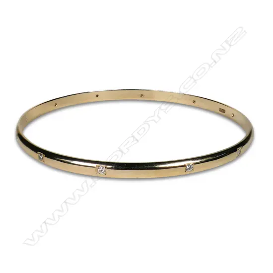 A modern 9ct yellow gold and diamond set bangle,