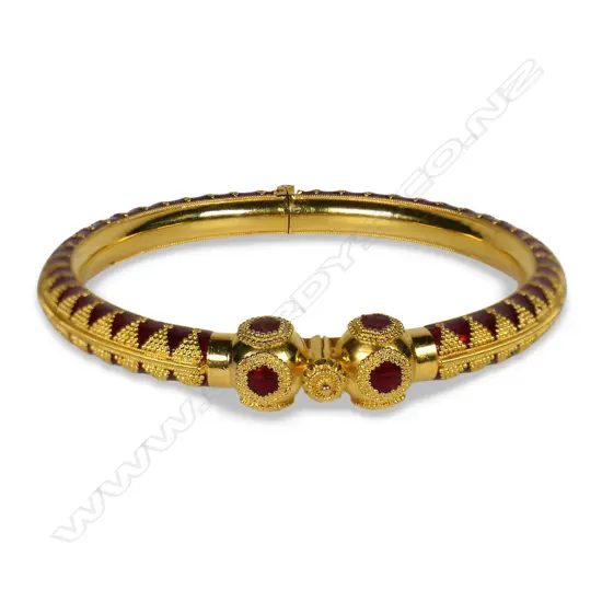 A 21ct gold and enamel hinged bangle,
