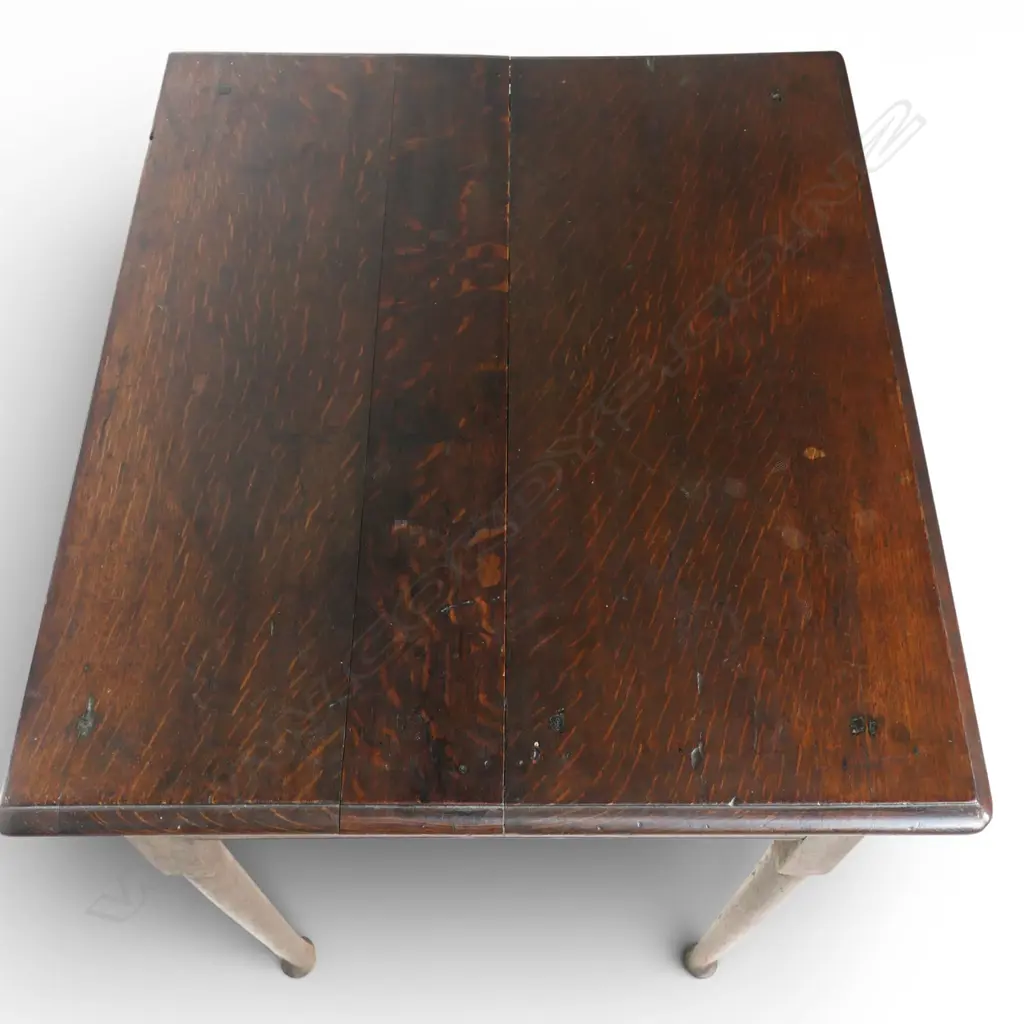 A George III country oak lowboy, single drawer, serpentine shaped frieze. Slender tapered cylindrical legs with pad feet. Top requires attention, some borer. 710 x 525 x 865mm. Provenance: From the estate of Adrian Michael Garrett of Kerikeri. Image 1++