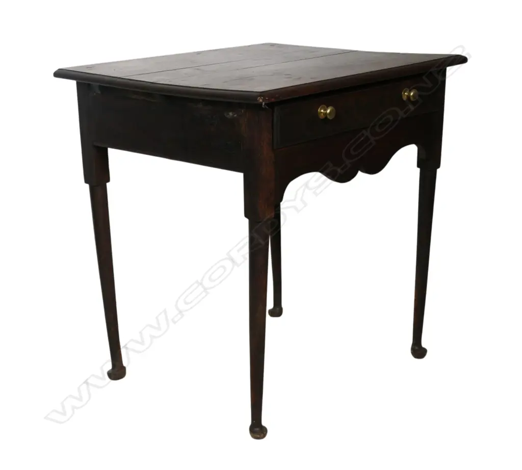 A George III country oak lowboy, single drawer, serpentine shaped frieze. Slender tapered cylindrical legs with pad feet. Top requires attention, some borer. 710 x 525 x 865mm. Provenance: From the estate of Adrian Michael Garrett of Kerikeri. Image 1++