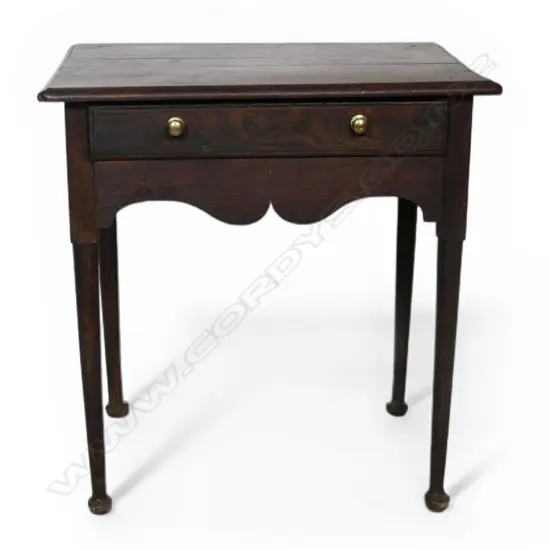 A George III country oak lowboy, single drawer, serpentine shaped frieze. Slender tapered cylindrical legs with pad feet. Top requires attention, some borer. 710 x 525 x 865mm. Provenance: From the estate of Adrian Michael Garrett of Kerikeri.