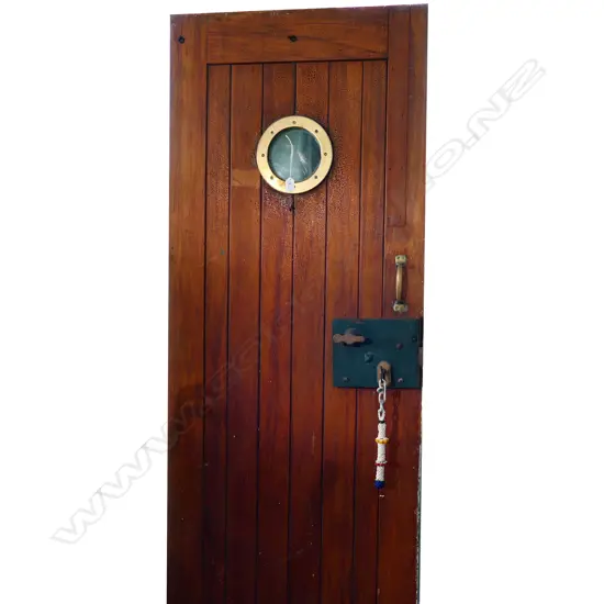 An early 20thC thick plank teak door from the Royal N.Z. navy prison (the brig) Devonport,